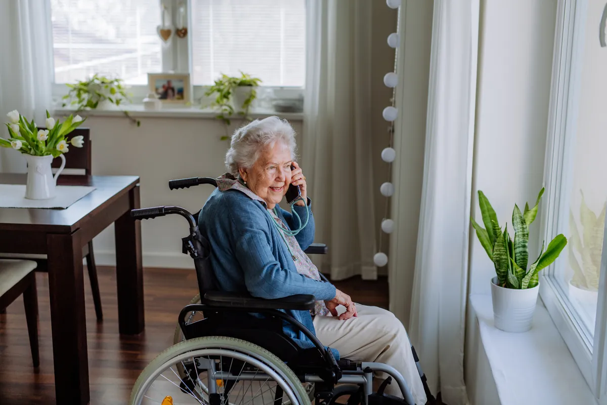 Elderly rider on the phone booking a paratransit trip